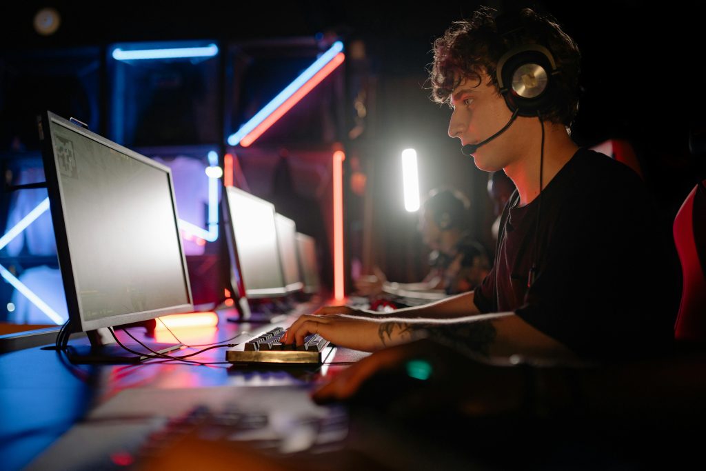 Man in Headphones Playing PC Game